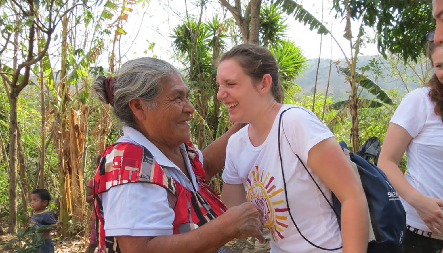 Student laughing with elderly widow